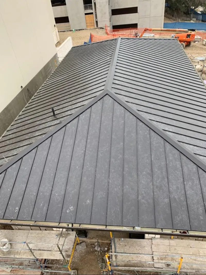 Commercial metal roof construction with crane equipment in Cocoa Beach